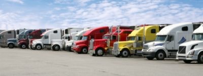 Fleet of colorful semi trucks parked in a row
